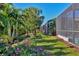 Landscaped backyard with lush tropical plants and trees at 8089 Sandstar Way, Sarasota, FL 34240