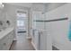 Modern bathroom with a walk-in shower and a double vanity at 8089 Sandstar Way, Sarasota, FL 34240