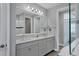 Elegant bathroom with dual vanity and a large mirror at 8089 Sandstar Way, Sarasota, FL 34240