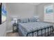 Guest bedroom with a queen-size bed and plenty of natural light at 8089 Sandstar Way, Sarasota, FL 34240