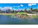 Aerial view of community clubhouse, pool, and lake at 8089 Sandstar Way, Sarasota, FL 34240