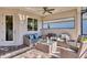 Relaxing covered patio with wicker furniture, perfect for outdoor entertaining at 8089 Sandstar Way, Sarasota, FL 34240