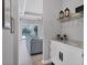 Entryway with a white cabinet, wine rack, and view into the living room at 8089 Sandstar Way, Sarasota, FL 34240