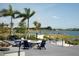 Relaxing fire pit area with lake views and comfortable seating at 8089 Sandstar Way, Sarasota, FL 34240