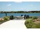 Lakefront fire pit with Adirondack chairs for enjoying the view at 8089 Sandstar Way, Sarasota, FL 34240