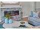 Modern electric fireplace with stone surround in living room at 8089 Sandstar Way, Sarasota, FL 34240