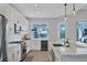 Modern kitchen with white cabinets, stainless steel appliances, and a wine cooler at 8089 Sandstar Way, Sarasota, FL 34240