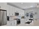 Modern kitchen with white cabinets, stainless steel appliances and quartz countertops at 8089 Sandstar Way, Sarasota, FL 34240