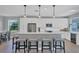 Modern kitchen with white cabinets, stainless steel appliances, and an island at 8089 Sandstar Way, Sarasota, FL 34240