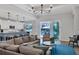 Open living room showcasing a comfortable seating area and view of the pool at 8089 Sandstar Way, Sarasota, FL 34240
