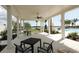 Covered patio with seating, lake views, and games at 8089 Sandstar Way, Sarasota, FL 34240