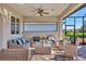 Spacious covered patio with wicker furniture and ceiling fan at 8089 Sandstar Way, Sarasota, FL 34240