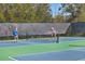 Two people playing pickleball on the community courts at 8089 Sandstar Way, Sarasota, FL 34240