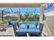 Relaxing pool area with patio furniture and a screened enclosure at 8089 Sandstar Way, Sarasota, FL 34240