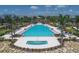 Community pool and spa with surrounding landscaping at 8089 Sandstar Way, Sarasota, FL 34240