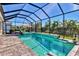 Enjoy this luxurious screened pool and spa with a waterfall feature at 8089 Sandstar Way, Sarasota, FL 34240