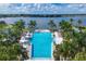 Relaxing resort-style pool with lake views and multiple lounging areas at 8089 Sandstar Way, Sarasota, FL 34240