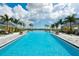 Stunning pool with lake views and plenty of lounge chairs at 8089 Sandstar Way, Sarasota, FL 34240