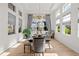 Sunlit dining room with hardwood floors and stunning water views at 8437 Cane Bay Ct, Lakewood Ranch, FL 34202