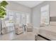 Bright bedroom with two armchairs and access to a private patio at 8544 Pavia Way, Bradenton, FL 34202