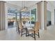 Elegant dining room with a modern light fixture and view of the pool area at 8544 Pavia Way, Bradenton, FL 34202