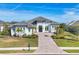 Two-story home with gray roof, white siding, and a paver driveway at 8544 Pavia Way, Bradenton, FL 34202