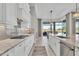 Bright kitchen with white cabinets, granite countertops and a large island at 8544 Pavia Way, Bradenton, FL 34202