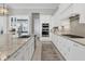 Modern kitchen with stainless steel appliances and white cabinetry at 8544 Pavia Way, Bradenton, FL 34202