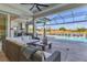 Covered lanai with outdoor kitchen and seating area near pool at 8544 Pavia Way, Bradenton, FL 34202