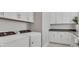 Bright laundry room with white cabinets and Whirlpool washer and dryer at 8544 Pavia Way, Bradenton, FL 34202