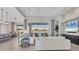 Spacious living area with open floor plan, large windows, and views of the pool at 8544 Pavia Way, Bradenton, FL 34202