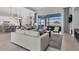 Open concept living room with kitchen and views of the pool and lake at 8544 Pavia Way, Bradenton, FL 34202