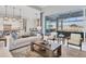 Living room with large windows, views of the pool and lake at 8544 Pavia Way, Bradenton, FL 34202