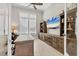 Home office with built-in shelving, large desk and a big screen TV at 8544 Pavia Way, Bradenton, FL 34202
