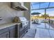 Modern outdoor kitchen features granite countertops and stainless steel appliances at 8544 Pavia Way, Bradenton, FL 34202
