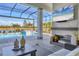 Luxury pool with covered lanai and fireplace, overlooking lake at 8544 Pavia Way, Bradenton, FL 34202