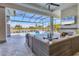 Spacious covered lanai with pool and fireplace overlooking lake at 8544 Pavia Way, Bradenton, FL 34202