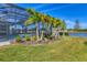Private pool and spa with screened enclosure, lush landscaping, and lake view at 8544 Pavia Way, Bradenton, FL 34202