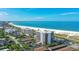 Aerial view of beachfront condo building with ocean and beach views at 101 Benjamin Franklin Dr # 54, Sarasota, FL 34236