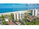 Aerial view of beachfront condo building with ocean views and parking at 101 Benjamin Franklin Dr # 54, Sarasota, FL 34236