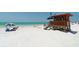 Relaxing beach view with lifeguard station at 101 Benjamin Franklin Dr # 54, Sarasota, FL 34236