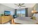 Bright bedroom with water view, bamboo furniture, and ceiling fan at 101 Benjamin Franklin Dr # 54, Sarasota, FL 34236