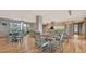 Bright community room with tables, chairs, and a kitchen area at 101 Benjamin Franklin Dr # 54, Sarasota, FL 34236