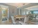 Elegant dining area with mirrored wall and round table at 101 Benjamin Franklin Dr # 54, Sarasota, FL 34236