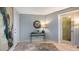 Condo entryway with contemporary decor, featuring a large artwork and a glass-top console table at 101 Benjamin Franklin Dr # 54, Sarasota, FL 34236