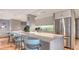 Modern condo kitchen with stainless steel appliances and breakfast bar at 101 Benjamin Franklin Dr # 54, Sarasota, FL 34236