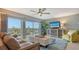 Bright and airy living room with large windows, offering stunning views and a comfortable seating area at 101 Benjamin Franklin Dr # 54, Sarasota, FL 34236