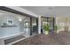 Condo lobby with seating area, plants, and access to the outside at 101 Benjamin Franklin Dr # 54, Sarasota, FL 34236