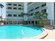 Inviting kidney-shaped pool with surrounding patio at 101 Benjamin Franklin Dr # 54, Sarasota, FL 34236