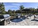 Outdoor grilling area with tables, chairs, and umbrellas at 10220 Silent Night Ln, Sarasota, FL 34241